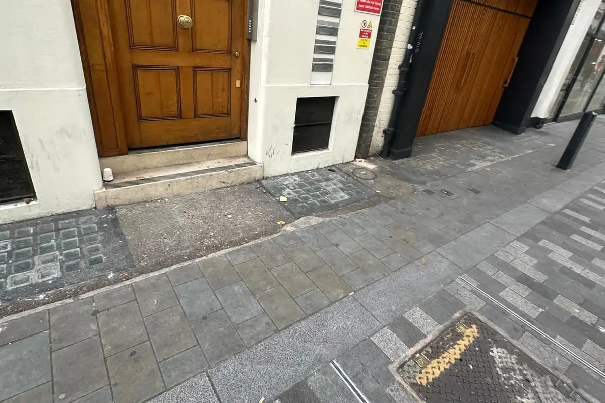 After: The pavement outside the wooden doorway cleared