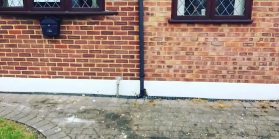 After: The block-paved drive in front of the brick house cleared